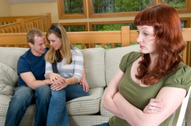 A woman experiences jealousy over this couples affection. A woman experiences jealousy over this couples affection.