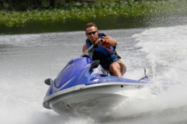 A man riding a Jet Ski. A man riding a Jet Ski.