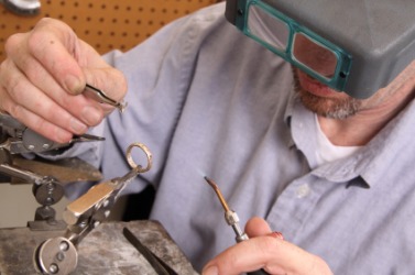 A jeweler at work. A jeweler at work.