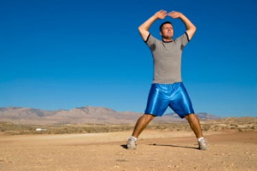 A man doing jumping jack exercises. A man doing jumping jack exercises.