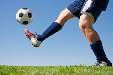 A soccer player kicks the ball. A soccer player kicks the ball.