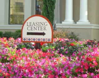 This sign indicates where you would go to lease an apartment. This sign indicates where you would go to lease an apartment.