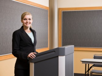 A woman standing at a lectern. A woman standing at a lectern.