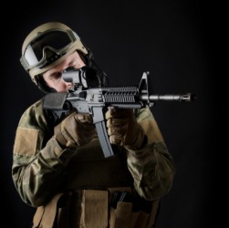 A soldier holding a machine gun. A soldier holding a machine gun.