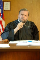 A magistrate considering a case. A magistrate considering a case.