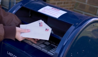 A person mailing some letters. A person mailing some letters.