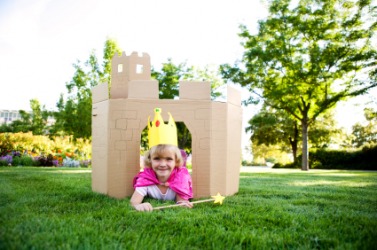 A little girl plays in her make-believe castle. A little girl plays in her make-believe castle.