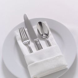 Flatware tucked into a napkin. Flatware tucked into a napkin.