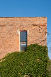 A narrow window in a brick building. A narrow window in a brick building.