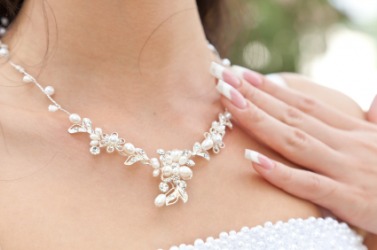 A woman wearing a necklace. A woman wearing a necklace.