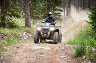 A man riding an off-road vehicle. A man riding an off-road vehicle.