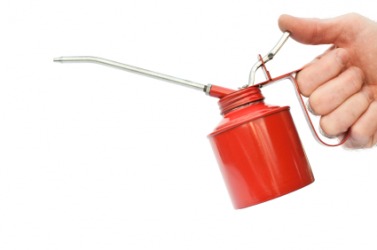A man holding an oilcan. A man holding an oilcan.