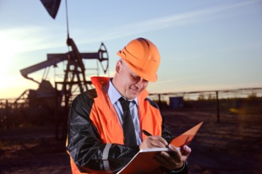 An oilman working in an oil field. An oilman working in an oil field.