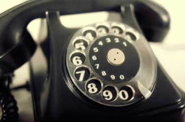 An old-fashioned rotary telephone. An old-fashioned rotary telephone.