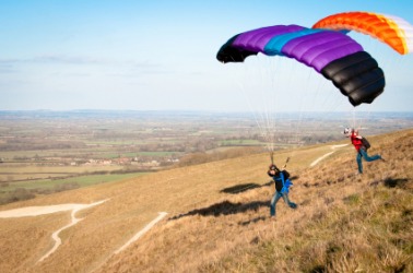 Two people paragliding. Two people paragliding.