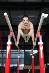 A gymnast on the parallel bars. A gymnast on the parallel bars.