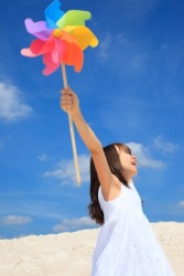A girl playing with a pinwheel also called a Catherine wheel. A girl playing with a pinwheel also called a Catherine wheel.