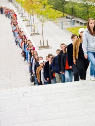 A lot of people waiting in a queue. A lot of people waiting in a queue.
