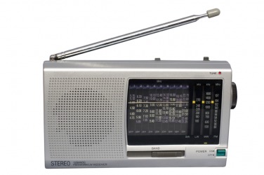 A person adjusts the volume of their car radio. A person adjusts the volume of their car radio.