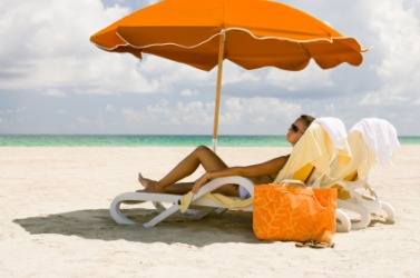 A woman reclines on the beach. A woman reclines on the beach.