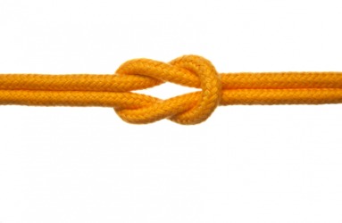 A reef knot in a yellow rope. A reef knot in a yellow rope.