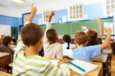 Students raise their hands in response to the teachers question. Students raise their hands in response to the teachers question.