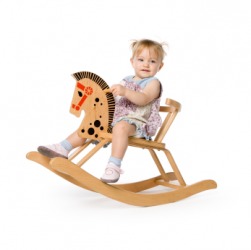 A little girl riding a cockhorse or rocking horse. A little girl riding a cockhorse or rocking horse.