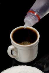 Saccharin being added to coffee. Saccharin being added to coffee.