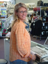 A salesgirl in a clothing store. A salesgirl in a clothing store.