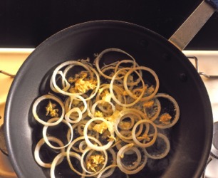 Onions being sauted in a pan. Onions being sauted in a pan.
