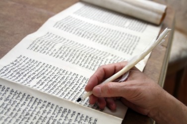 A scribe writing in a scroll. A scribe writing in a scroll.