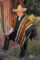A man wearing a serape. A man wearing a serape.
