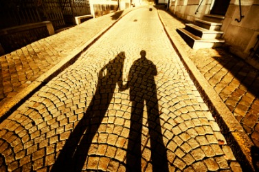 Two long shadows on an old street. Two long shadows on an old street.