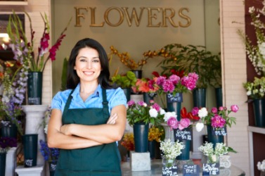 This woman works in a flower shop. This woman works in a flower shop.