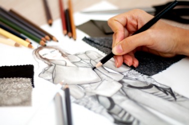 A fashion designer works on a sketch. A fashion designer works on a sketch.