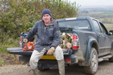A man sitting on the tailgate of his truck. A man sitting on the tailgate of his truck.