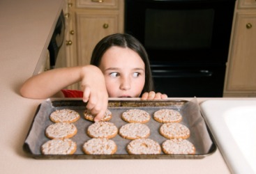 This girl is taking a cookie. This girl is taking a cookie.