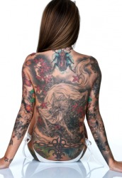 This woman has a lot of tattoos. This woman has a lot of tattoos.
