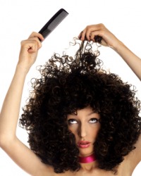A woman teases her hair. A woman teases her hair.