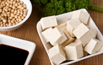 A bowl filled with white cubes of bean curd or tofu. A bowl filled with white cubes of bean curd or tofu.