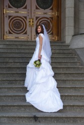 A bride wears a dress with a long train. A bride wears a dress with a long train.