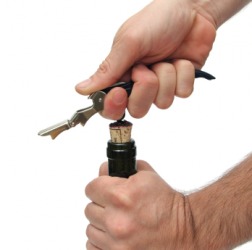A man uncorks a bottle of wine. A man uncorks a bottle of wine.