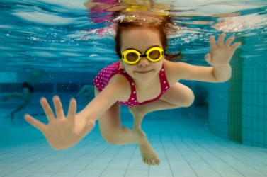 A little girl swims underwater. A little girl swims underwater.