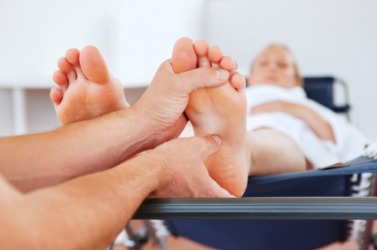 A person gets a foot massage to unwind. A person gets a foot massage to unwind.