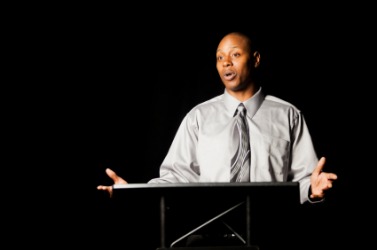A man delivering a verbal presentation. A man delivering a verbal presentation.