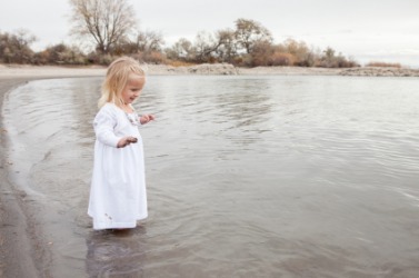 A little girl wades in the water. A little girl wades in the water.