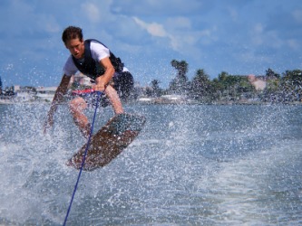 A man on a wakeboard. A man on a wakeboard.