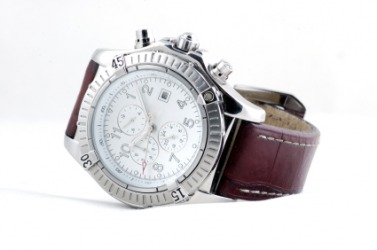 A watch with a leather watchband. A watch with a leather watchband.