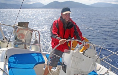 A yachtsman steers his boat. A yachtsman steers his boat.
