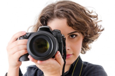 A woman takes a picture with her camera. A woman takes a picture with her camera.